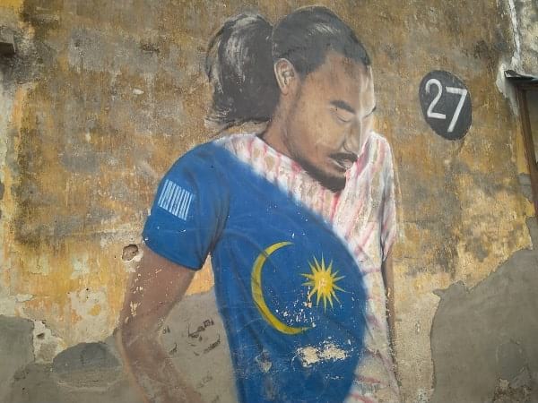 A guy in a shirt designed with a Malaysian flag
